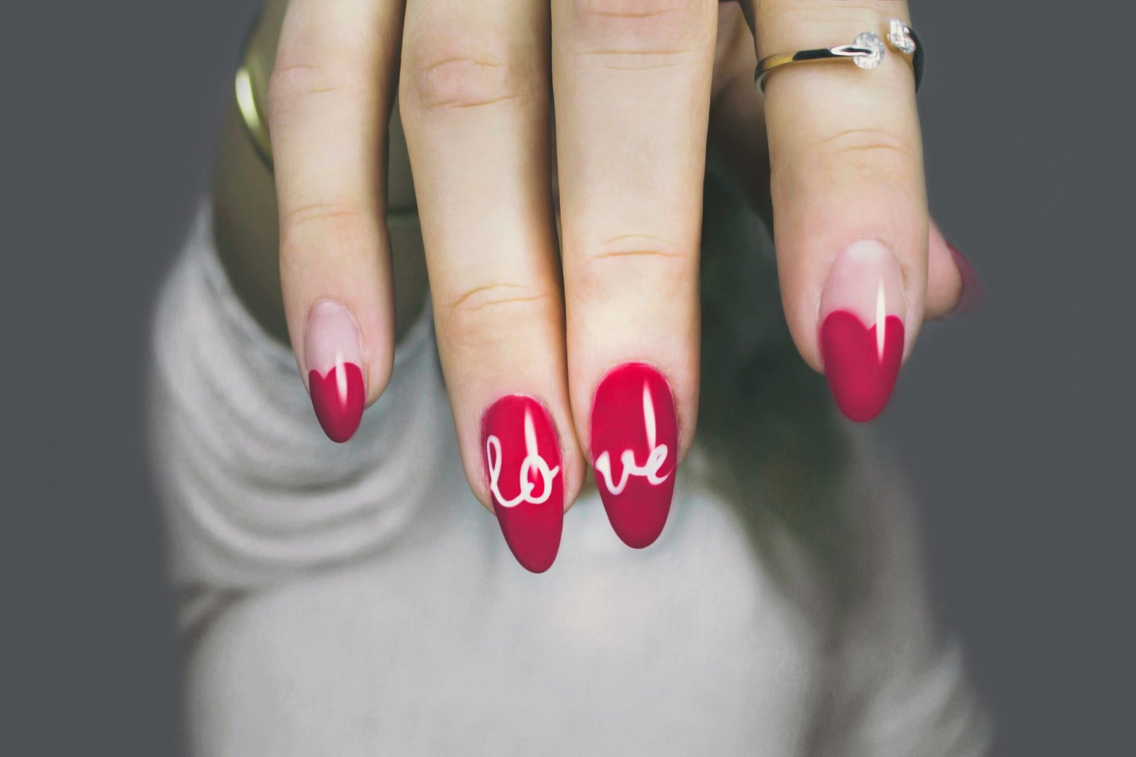 selective focus photography of woman's pink manicure